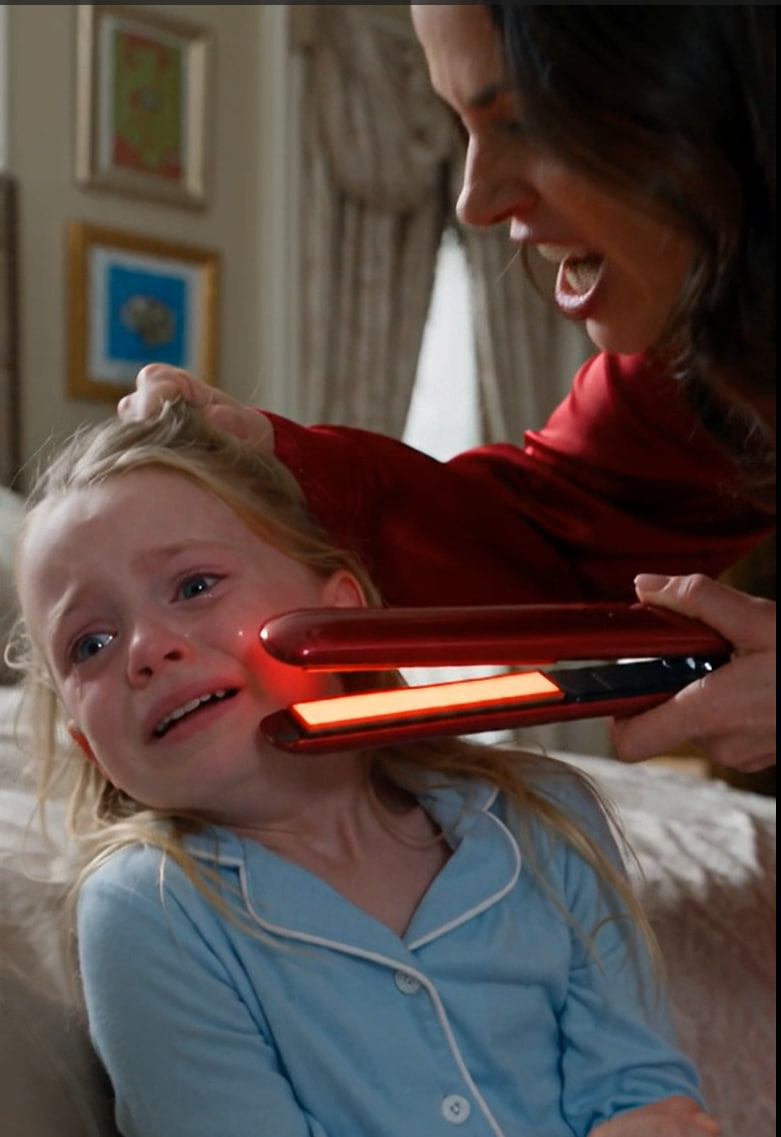 I heard my five-year-old daughter screaming from her bedroom and found my wife holding a hot hair straightener inches from the child’s face.