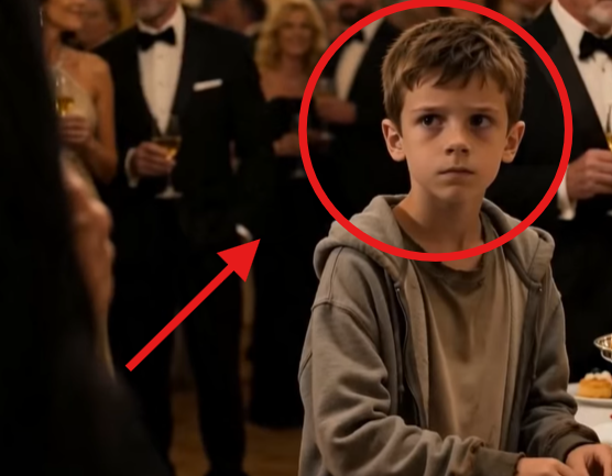 The boy stood beside the buffet table in a worn grey hoodie, quietly taking small pieces of food while rich guests laughed under the chandeliers.